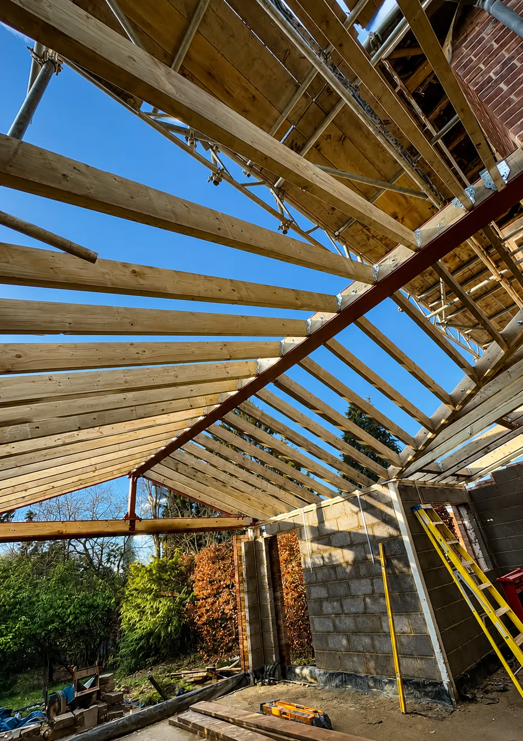 Hand-cut pitched roof timber frame under construction